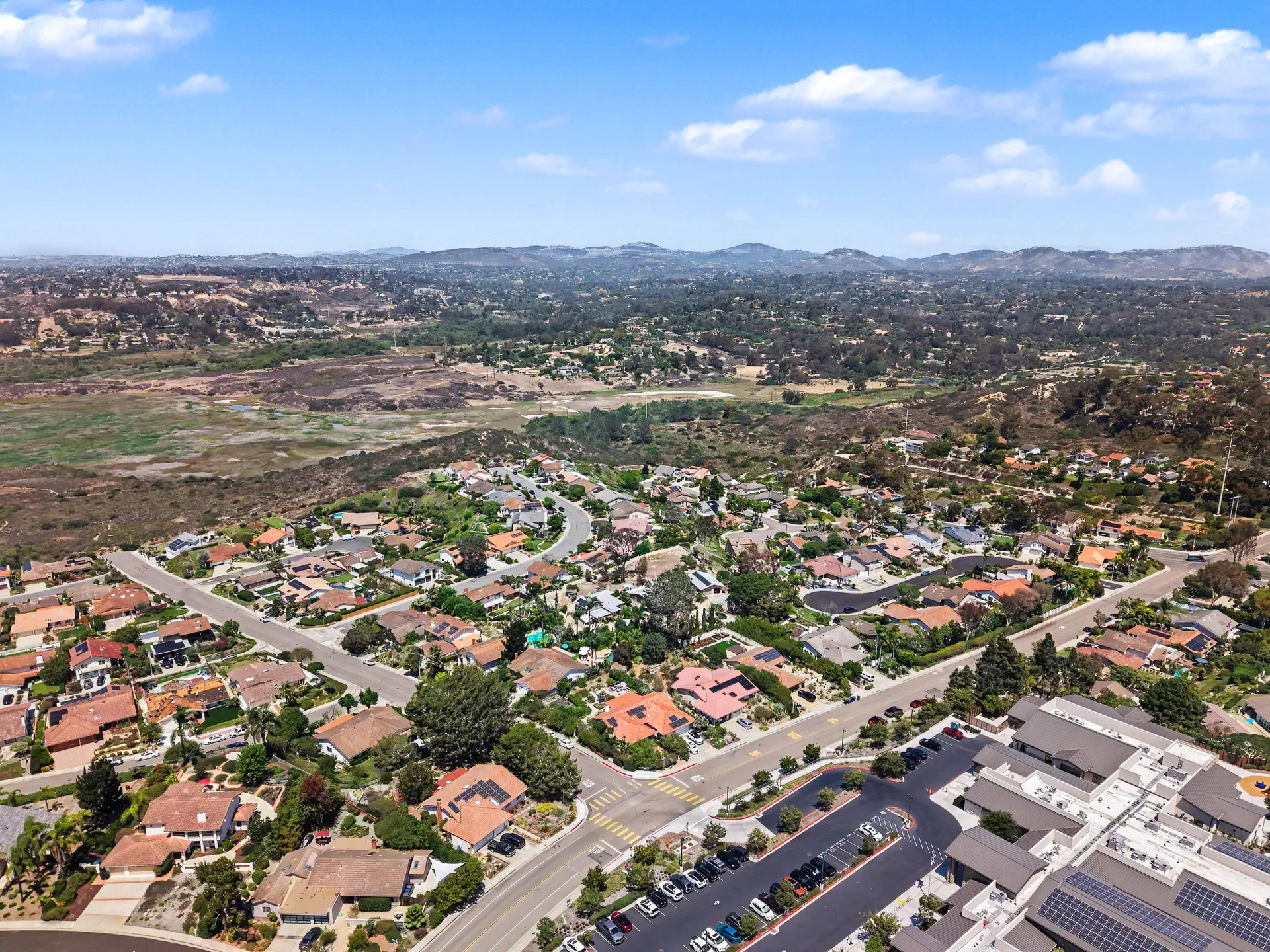 Aerial view east from above the parcel toward the inland hills and open space.