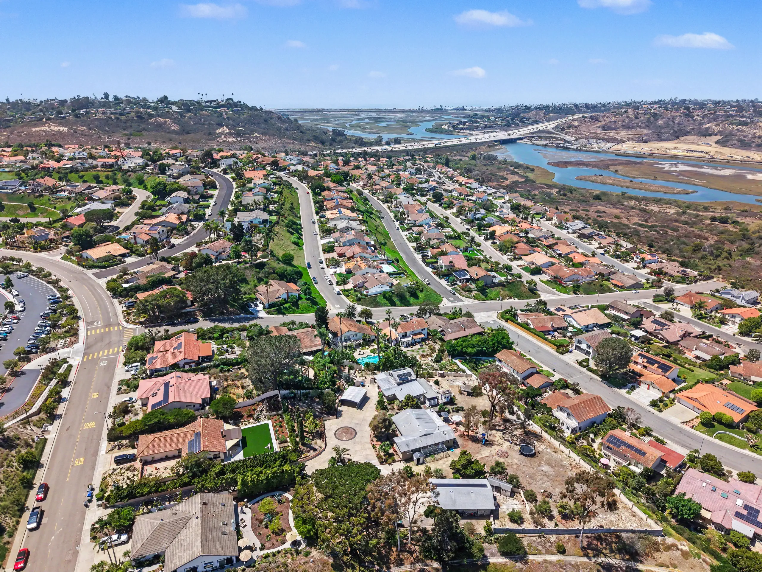 Aerial view of the parcel on its ridge with San Elijo Lagoon and the coastline opening beyond.