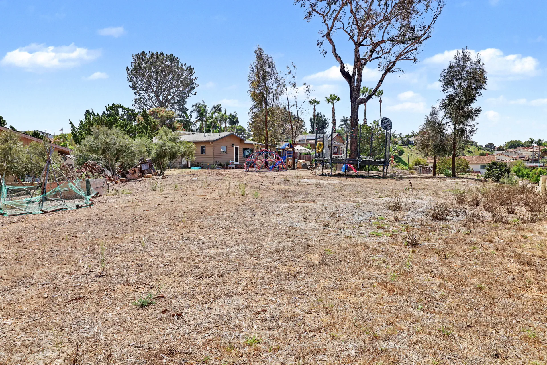 Open, level ground on the southern half of the parcel with trees along the boundary.