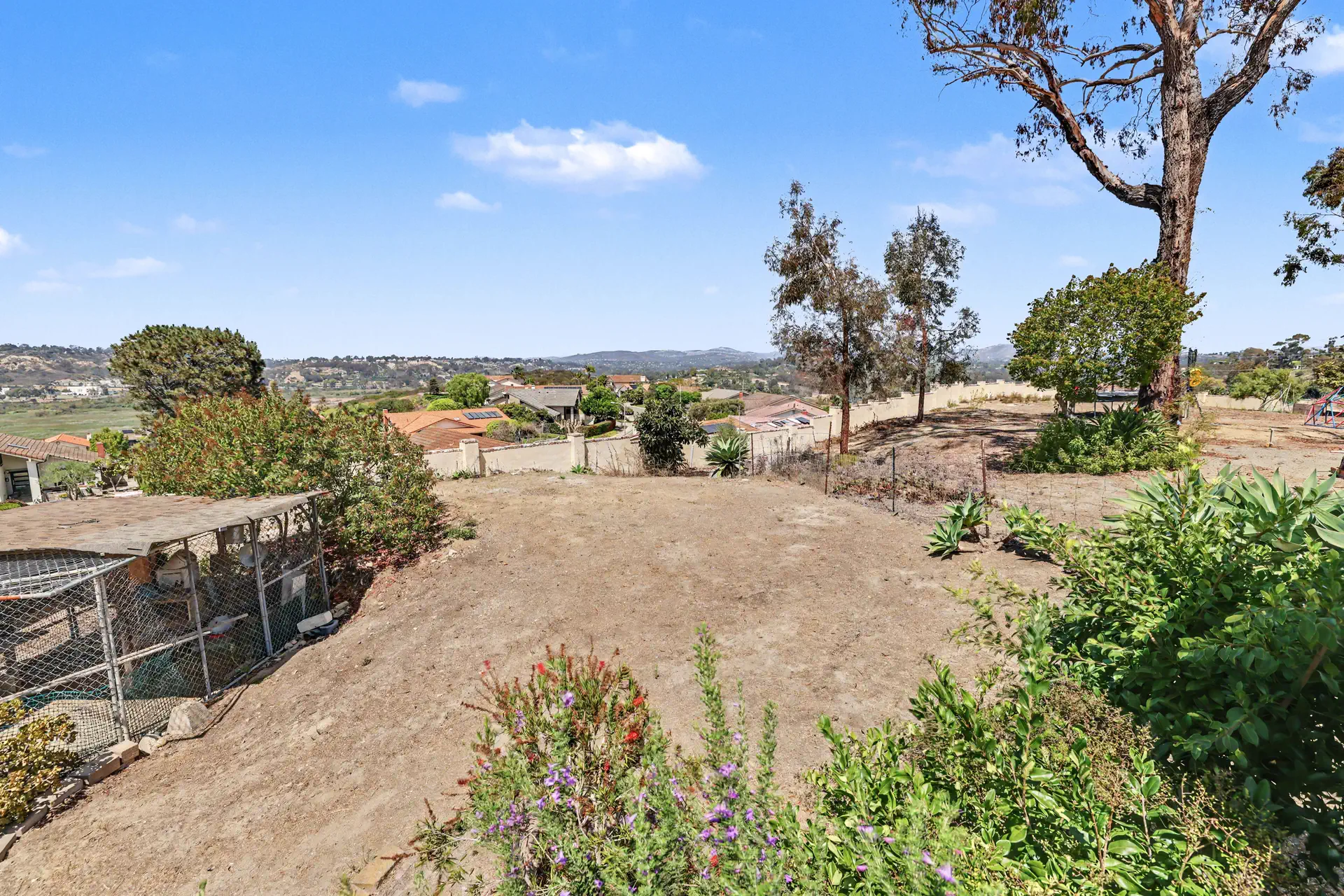 Rear ground opening east toward the rolling inland hills.